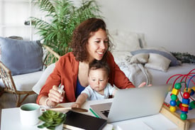 Woman working with baby on her lap