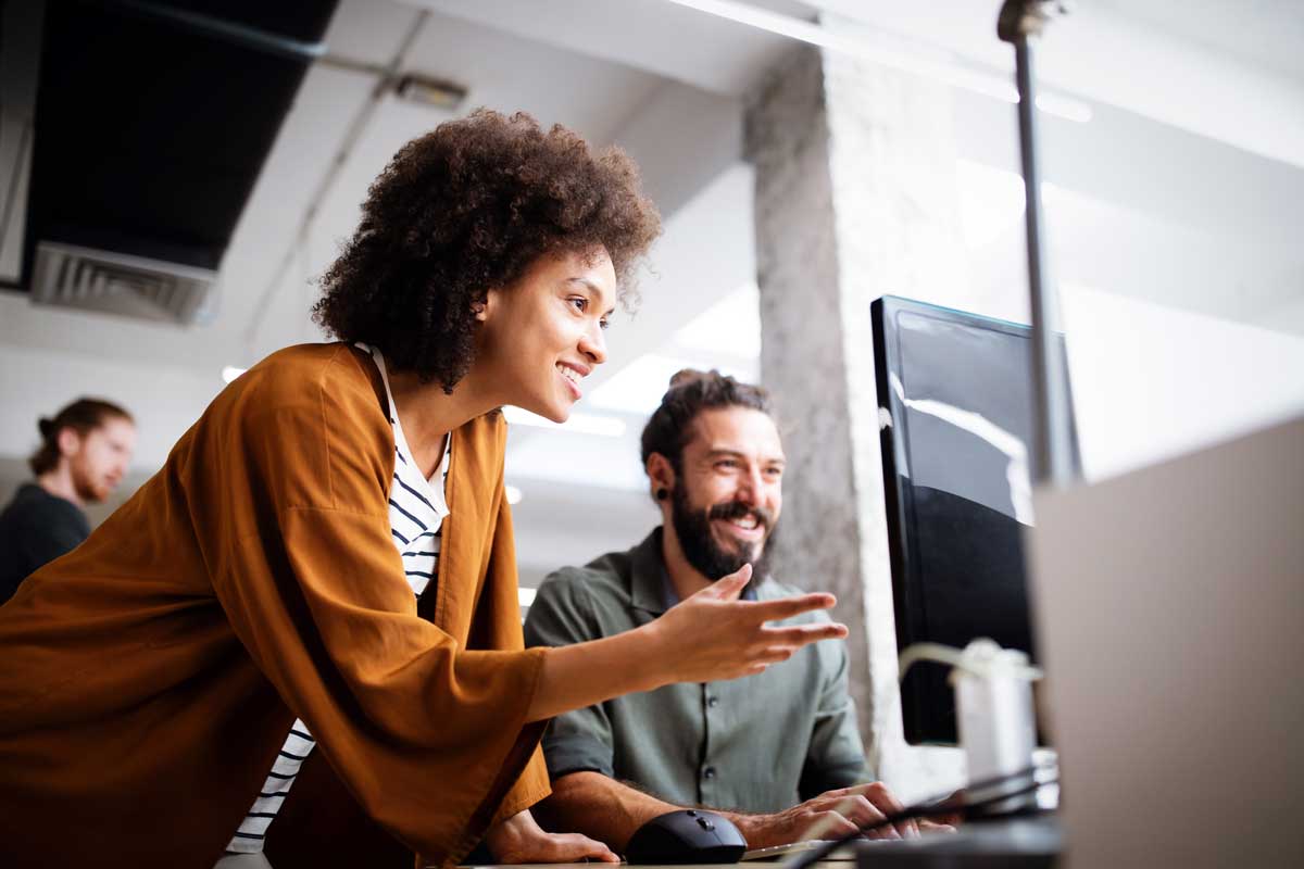 Woman and man look at a computer screen